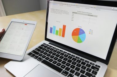 pexels-photo-265087-265087 Laptop displaying charts and graphs with tablet calendar for data analysis and planning.